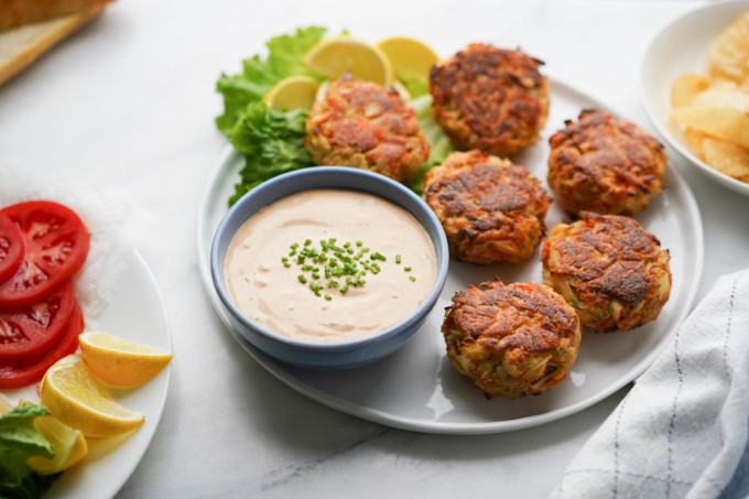 bowl of crab cake sauce with fried crab cakes