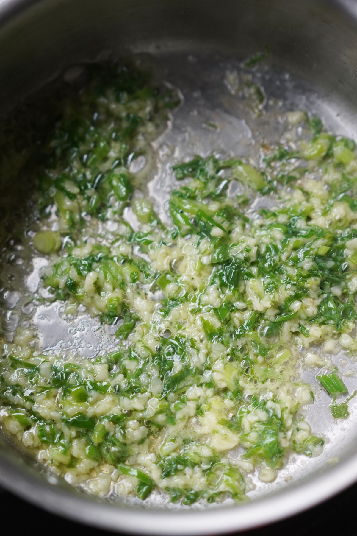 sautéing garlic and green onions in a pan