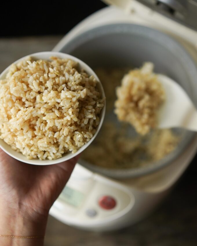 scooping a bowl of brown rice