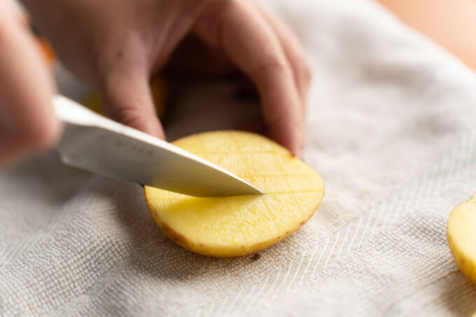 scoring potatoes with knife