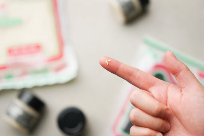 sesame seed closeup on finger