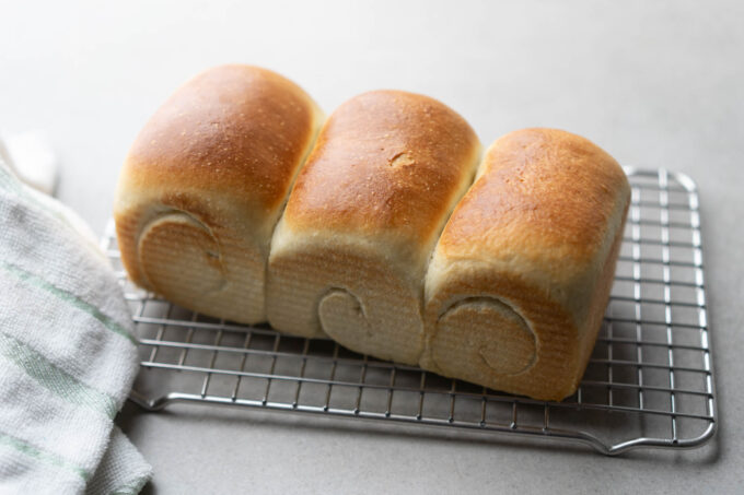 shokupan bread resting on cooling rack