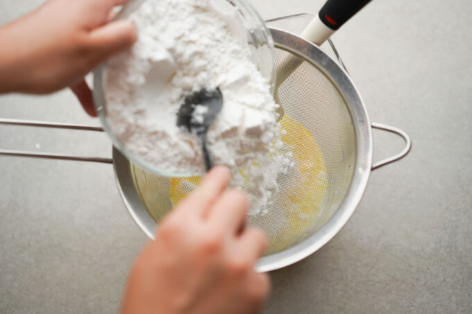 sifting dry ingredients into the wet