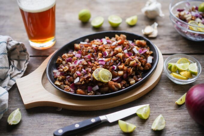 Filipino sisig on sizzling cast iron platter