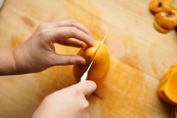 cutting left and right sides off a mango