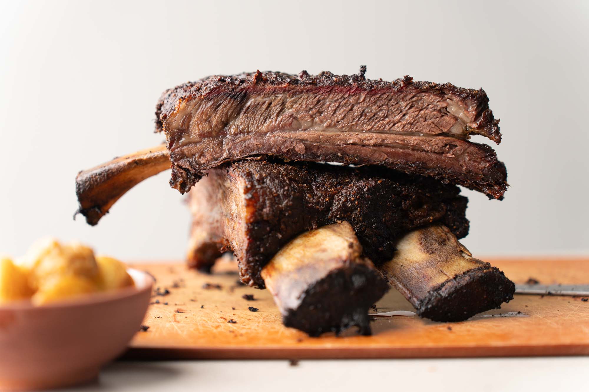 smoked beef ribs on cutting board