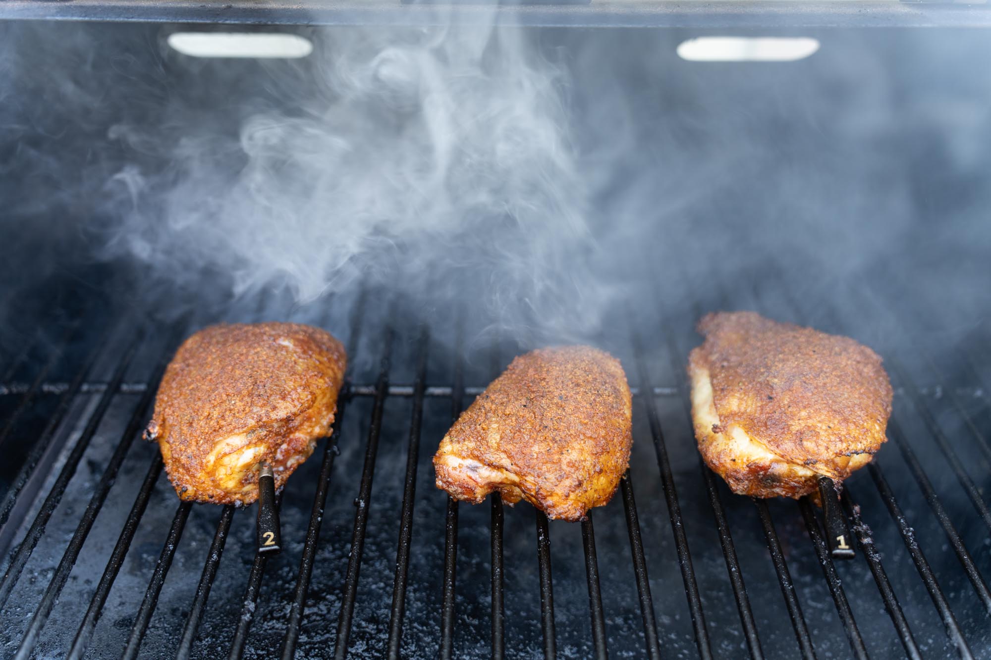 smoked chicken thighs on grill grates