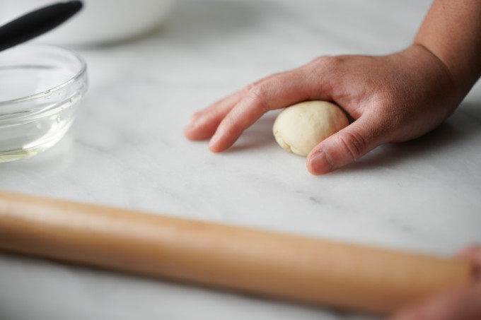 rolling dough to form into a ball