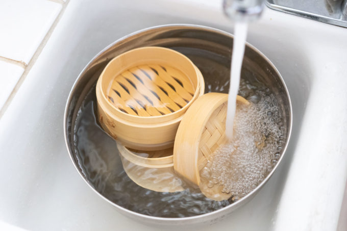 soaking bamboo steamers in water