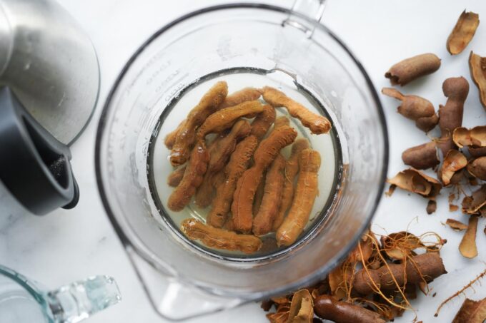 peeled tamarind pods, soaking in water