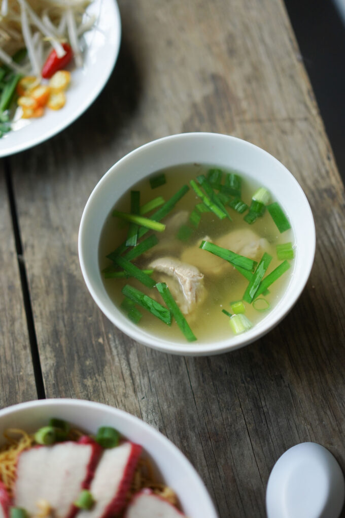 a small side bowl of pork soup, with spare ribs and chives