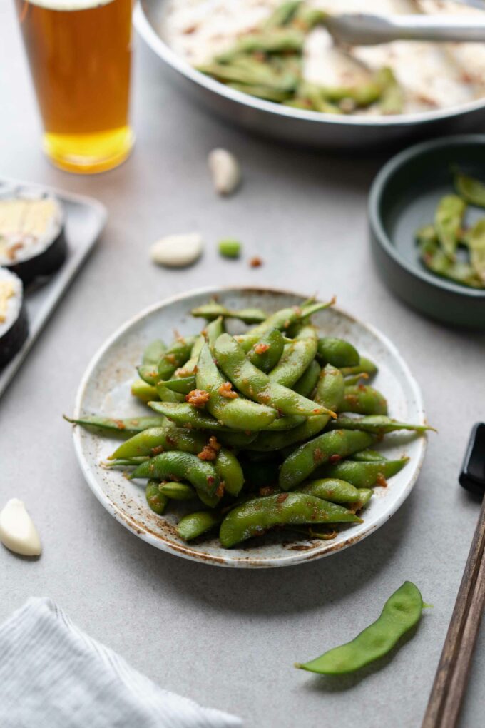 spicy edamame with maki cut rolls and beer