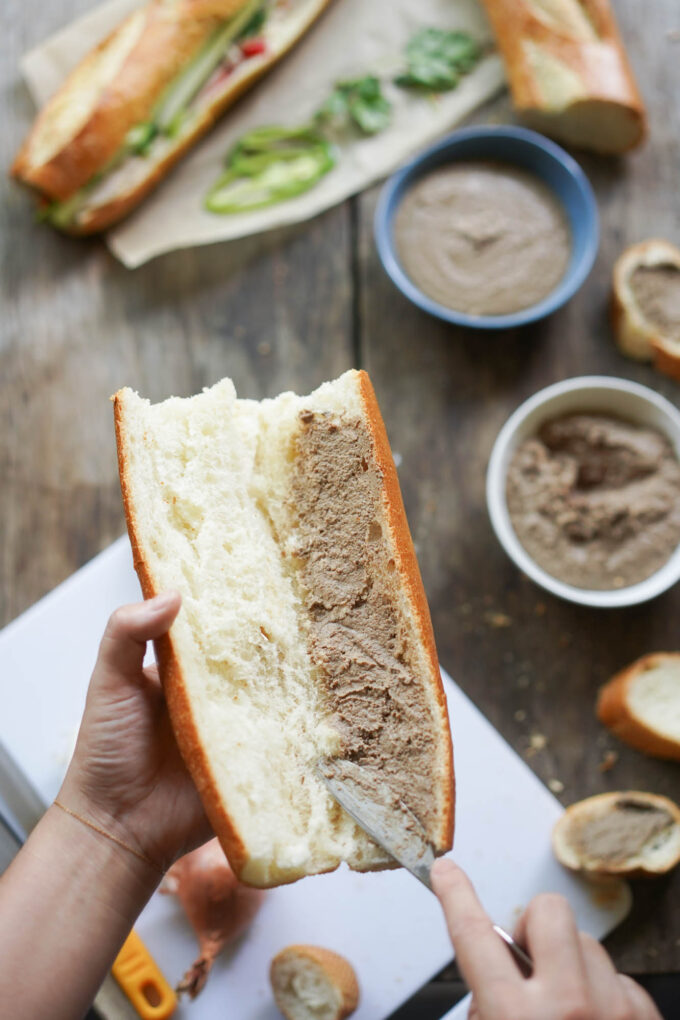 spreading chicken liver / pate onto a cut baguette