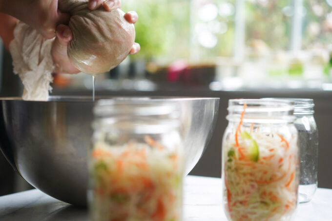 wringing out moisture from cheesecloth wrap