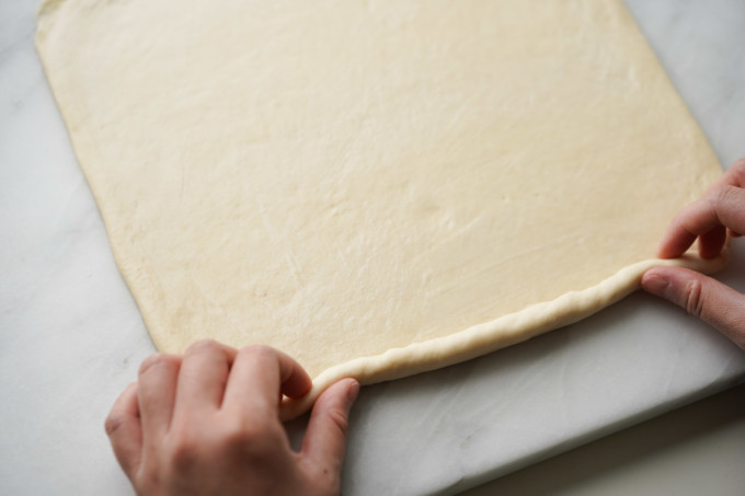 starting bottom edge of dough rolling