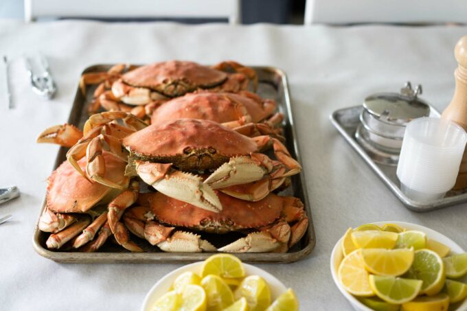 tray of steamed Dungeness crab with lemons, salt, pepper