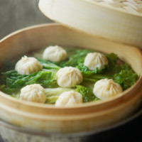 bamboo steamer full of xiao long bao soup dumplings