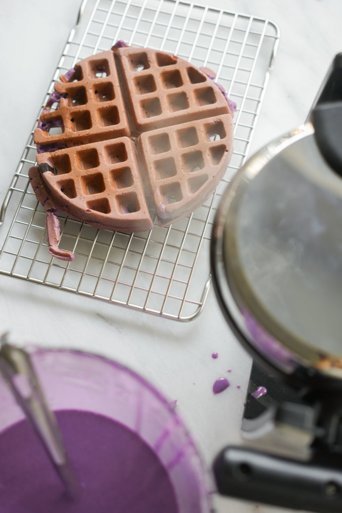cooling ube waffle next to waffle iron