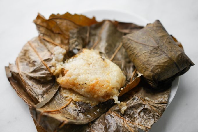 lo mai gai - sticky rice with unwrapped lotus leaf