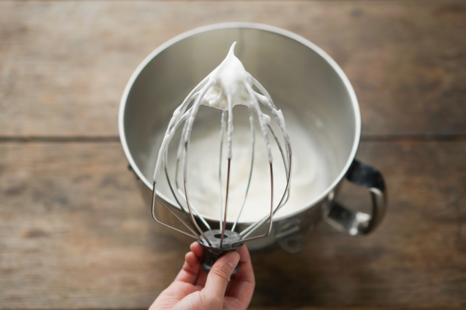 stiff peaks of meringue on a stand mixer whisk