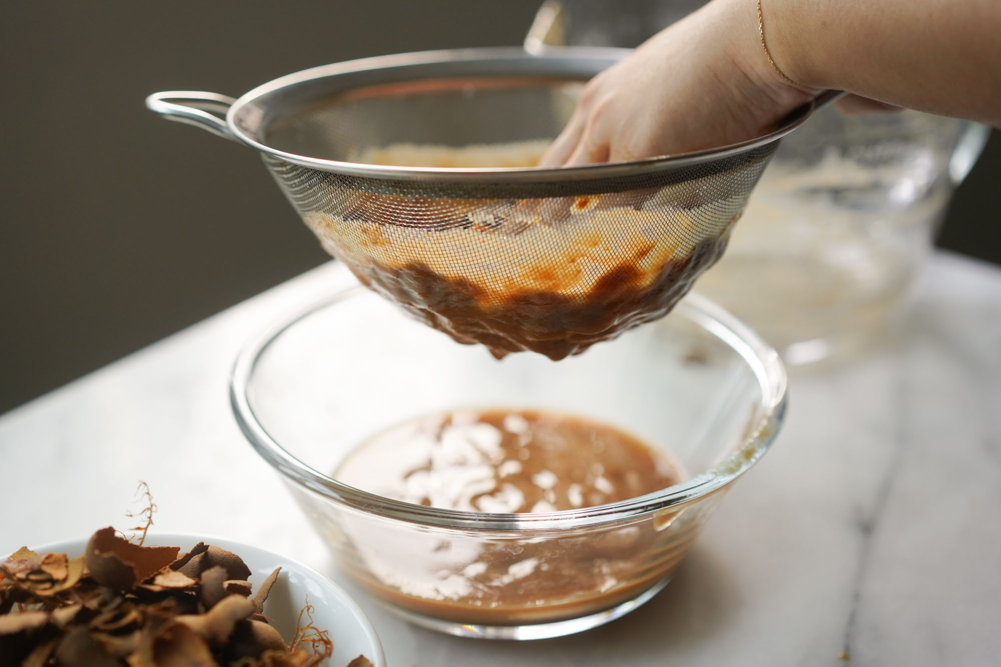 straining tamarind pulp and seeds