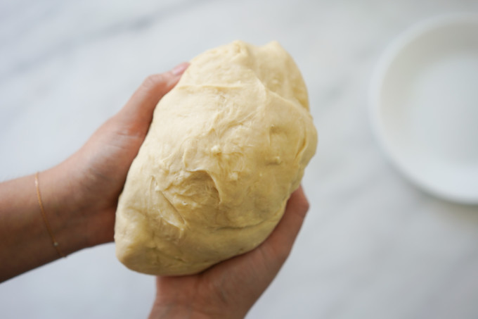 holding mixed dough in hands