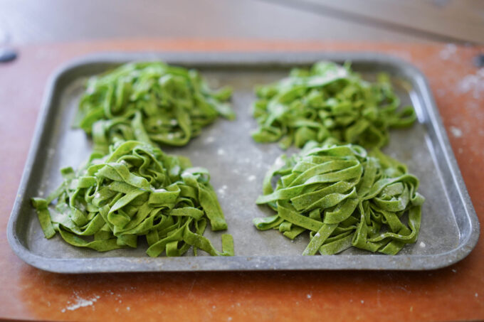 nests of pasta on a metal tray