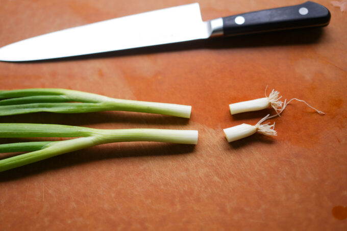 trimming off green onion roots