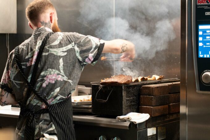 chef smoking meat at trust