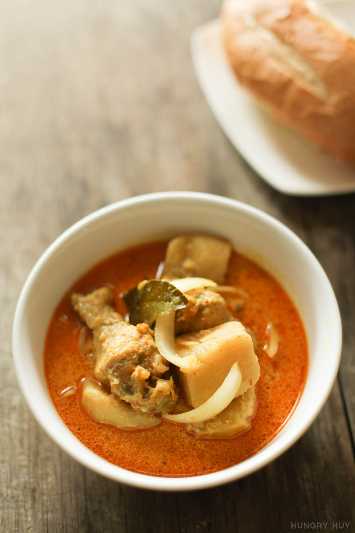 Vietnamese curry with chicken, baguette on the side