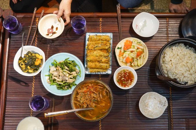 assortment of Vietnamese dishes on a dining table