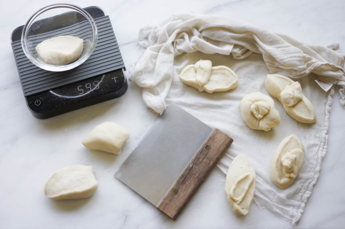 cutting and weighing out dough portions for bao