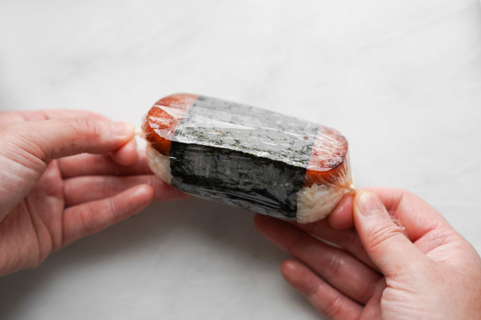 Spam musubi wrapped in plastic cling wrap