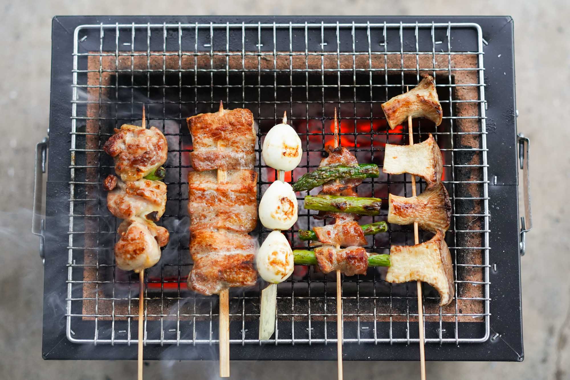 yakitori skewers on a smoky konro grill